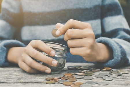 Hands girl holding coin selective and soft focus hipster toneの写真素材