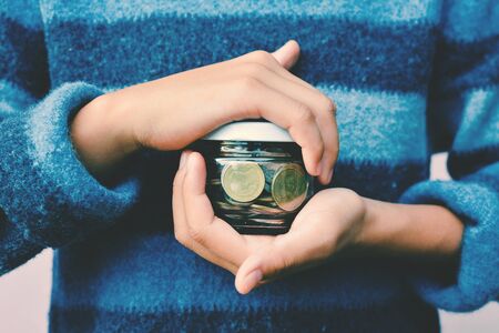 Hands girl holding coin selective and soft focus hipster toneの写真素材