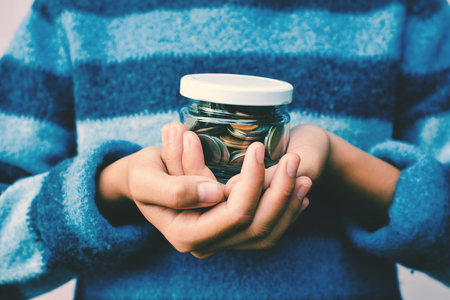 Hands girl holding coin selective and soft focus hipster toneの写真素材