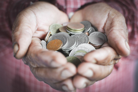 Old hands holding coins selective and soft focus vintage toneの写真素材