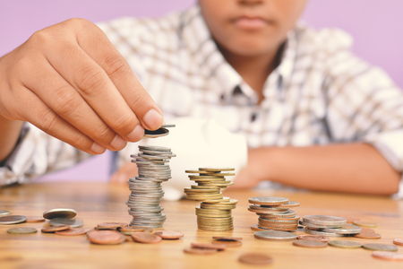 Hands boy holding coin selective and soft focus hipster toneの写真素材