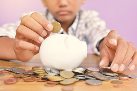 Hands boy holding coin selective and soft focus hipster toneの写真素材