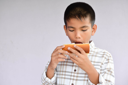 Boy eating ice cream in summerの写真素材