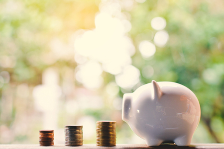 coins and piggy bank concept save money ,selective and soft focus vintage toneの写真素材