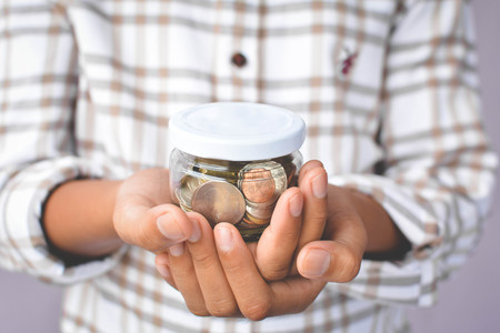 Hands boy holding coin selective and soft focus hipster toneの写真素材
