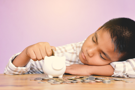 Hand boy holding coin and piggy bank concept save money selective and soft focus hipster toneの写真素材