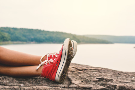 Feet of young girl sleep in the park on nature, Relax time on holiday concept travel ,color of hipster toneの写真素材