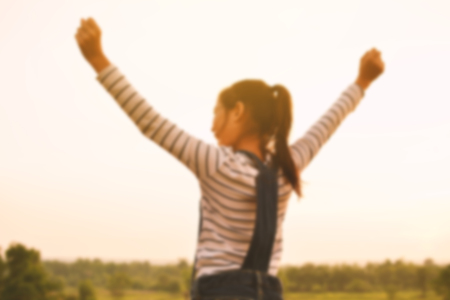 Happy Asian girl in nature background, Relax time on holiday , color of vintage tone and blurred focusの写真素材