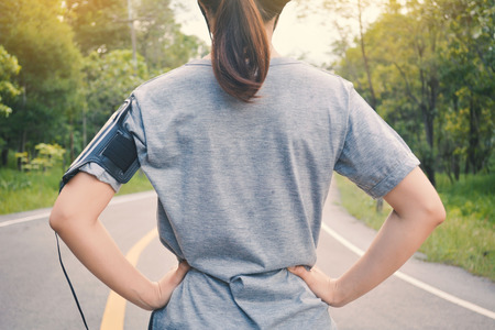 Women running on the road for health, color of vintage tone selective and soft focusの写真素材