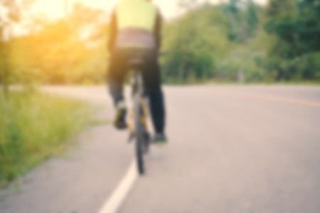 People cycling on lane in the park blur of focusの写真素材