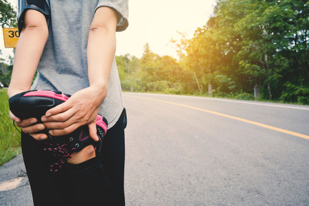 Women running on the road for health, color of vintage tone selective and soft focusの写真素材