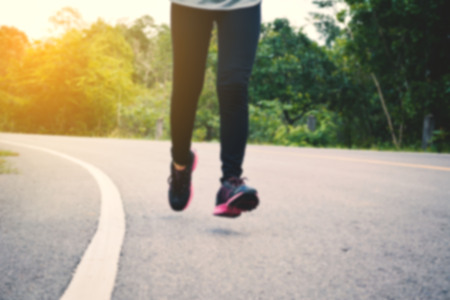 Women running on the road for health,vintage tone and blurred focusの写真素材