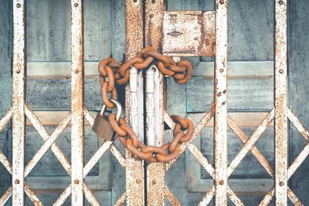 Old door with key and chains color vintage styleの写真素材