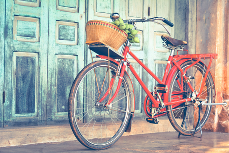 Hipster red bicycle in old building walls background , color if vintage toneの写真素材