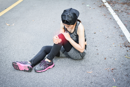 Women accident during running on the road , color of vintage tone selective and soft focusの写真素材