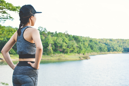 Women exercise standing on nature background , color of hipster tone selective and soft focusの写真素材