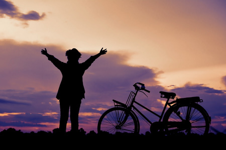 Silhouette happy Asian hipster women with bicycle color of vintage tone, Travel on holiday relax time, selective and soft focusの写真素材