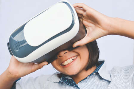 Asian girl playing VR virtual reality glass box ,color of vintage style and soft focusの写真素材
