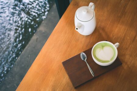 Green tea cup in cafe shop time to relax ,hipster tone and soft of focus
