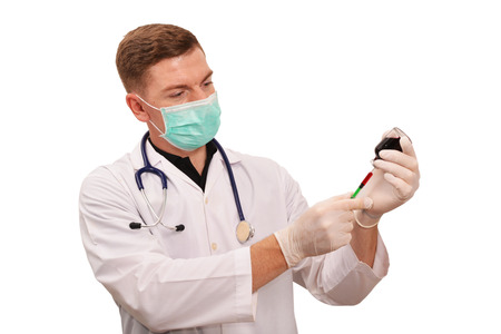 Portrait of young male doctor hand holding injection needle working on white backgroundの写真素材