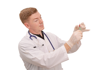 Portrait of young male doctor hand holding injection needle working on white backgroundの写真素材