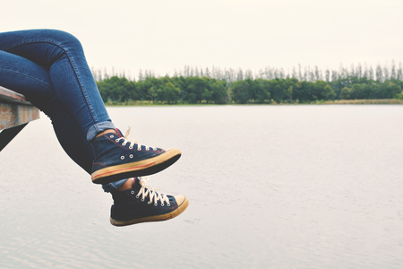 Feet of hipster women in park and nature background, Relax time on holidayの写真素材