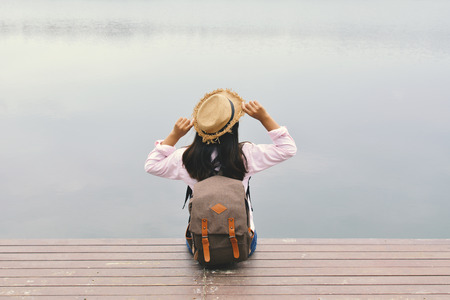 Happy Asian women backpack in nature background, Relax time on holiday concept travel color of hipster styleの写真素材