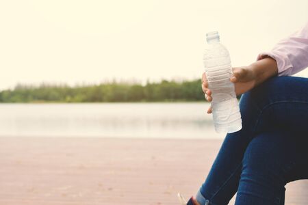 Women holding bottle of water during travelの写真素材