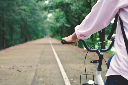 Happy women backpacker with white bicycle in nature background, Relax time on holiday concept travel color of hipster style selective and soft focusの写真素材