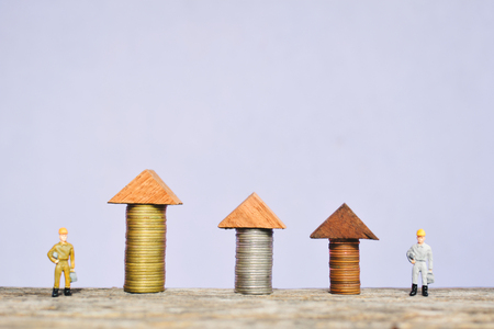 miniature worker team and and coin on wood concept to save money for my home , soft focusの写真素材