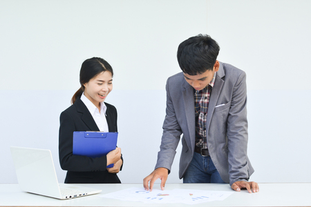 Asian business people talking about report and working with paper sheetの写真素材