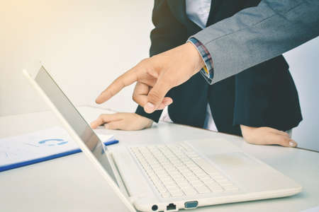 Asian business people working with computer and sheet color hipster toneの写真素材