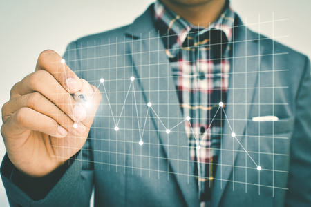 Close up of hand businessman drawing financial graphの写真素材