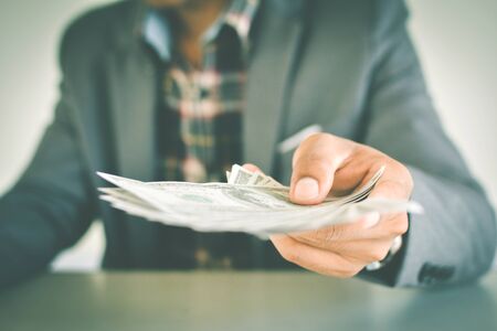 Close up of hand businessman holding money color of vintage toneの写真素材