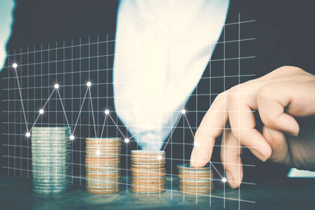 Business women saving for money with financial graphの写真素材