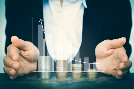 Business women saving for money with graph and arrowの写真素材