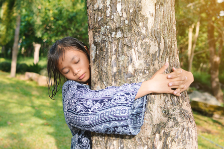 Girl hugging big tree color of hipster tone selective soft focus, concept nature and peopleの写真素材