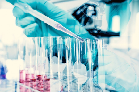 Double exposure of science experiment  hand holding test tube in the laboratoryの写真素材