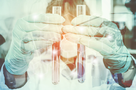 Double exposure of science experiment  hand holding test tube in the laboratoryの写真素材
