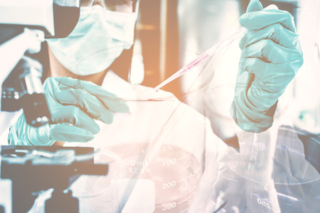 Double exposure of science experiment  hand holding test tube in the laboratoryの写真素材
