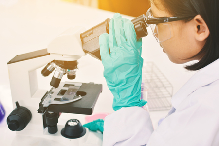 scientist student using microscope experiment  in the laboratoryの写真素材