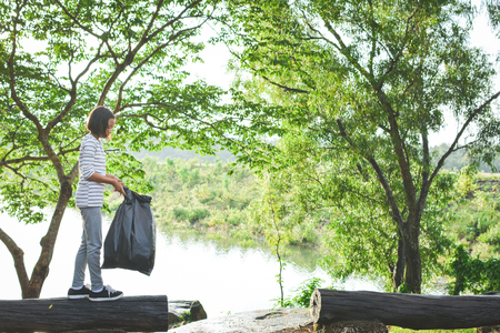 Girl holding bin bag volunteer conceptの写真素材