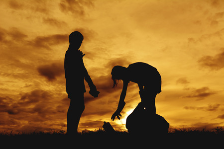 Silhouette of children hands picking up plastic into bin bag ,volunteer conceptの写真素材