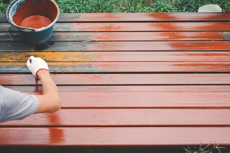 Close up man at work hand holding brush painting on steel selective and soft focus color hipster styleの写真素材