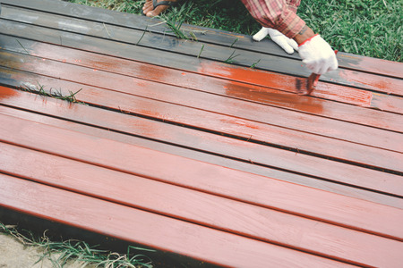 Close up man at work hand holding brush painting on steel selective and soft focus color hipster styleの写真素材
