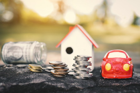 Coins and wood house on rock background concept save money for home ,selective and soft focus vintage toneの写真素材