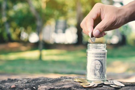 Hand and coins concept save money ,selective and soft focus vintage toneの写真素材