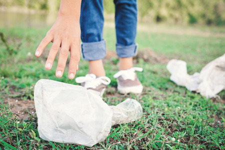 Girl picking garbage in park ,volunteer conceptの写真素材