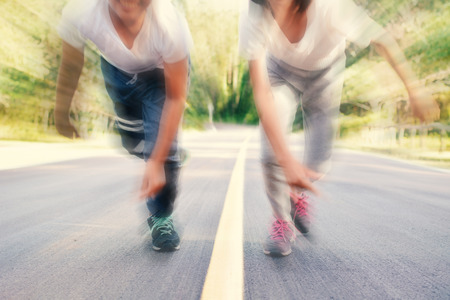 Blurred of focus boy and girl running on the road