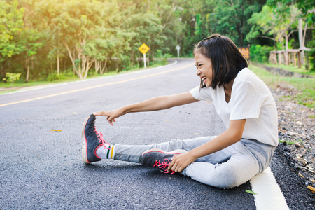 Girl warm up before running on the road, color of hipster tone selective and soft focusの写真素材